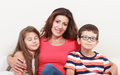 Obraz premium Happy family. Mother and kids on sofa at home.