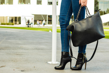woman legs in heels shoes handbag in hand