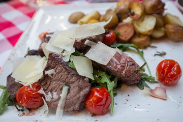Steak pieces, tomatoes and potatoes