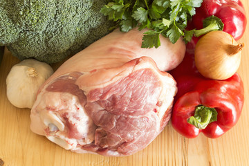 Pork knuckle and vegetables on the plank table