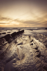 Fototapeta na wymiar Barrika beach at sunset. Long exposure in the rocky shore