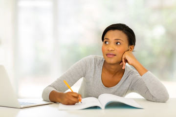 thoughtful young woman studying