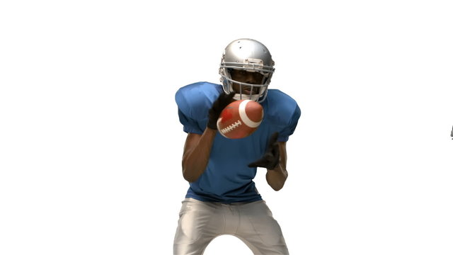 Serious american football player tackling for ball