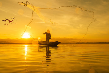 Fisherman fishing at lake in Morning, Thailand.