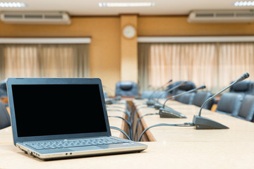 Before a conference - Laptop in front of empty chairs at confere