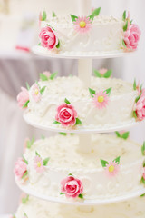 Fototapeta na wymiar White wedding cake decorated with sugar flowers