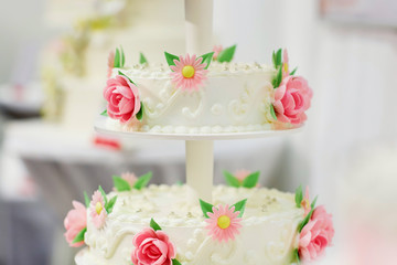 White wedding cake decorated with sugar flowers