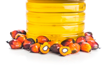 Refined palm oil in bottle with fresh oil palm fruits.