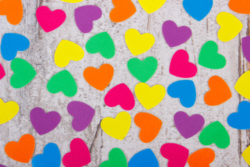 Colorful hearts of paper for valentines on old wooden background