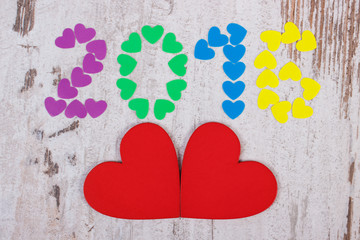 Happy new year 2016 made of colorful hearts and red wooden hearts