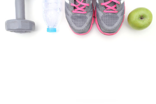 Sport shoes and water with set for sports activities on white with copy space