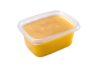 plastic container with ghee butter isolated on white background
