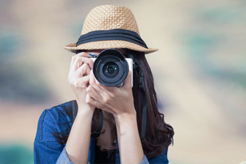 woman traveler wearing blue dress as photographer, take photo wi