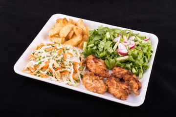 fried chicken with salad and potatoes