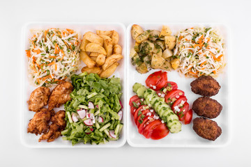 fried meatballs and chicken with salad and potatoes