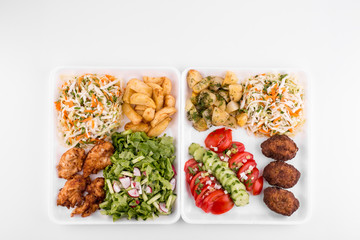 fried meatballs and chicken with salad and potatoes - copy space