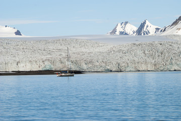 Sailing boat in front of the glacier in Svalbard, Arctic