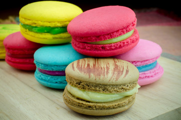 Close up of colorful macarons on wooden background, vintage pastel tones and Selective focus
