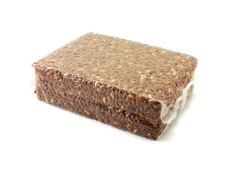 brown rice in vacuum package on white background