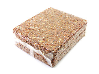 brown rice in vacuum package on white background