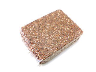 brown rice in vacuum package on white background