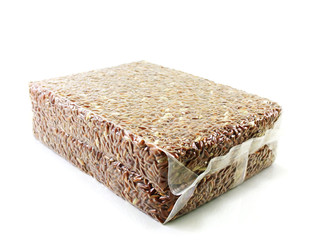 brown rice in vacuum package on white background