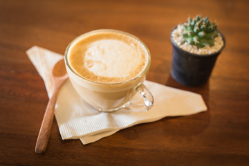 Hot art Latte Coffee in a cup on wooden table and Coffee shop bl