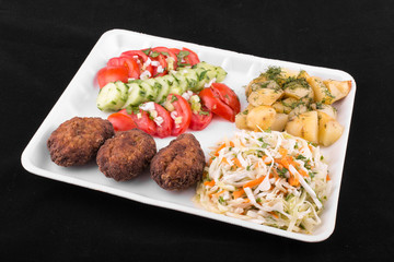 fried meatballs with salad and potatoes