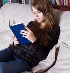 Obraz premium Woman at the library reading book
