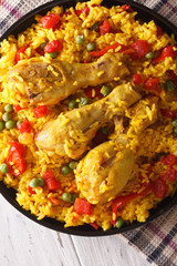 paella with chicken and vegetables close-up. vertical top view
