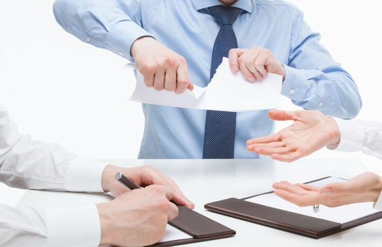 Business people cruelly tearing documents
