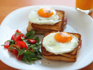 Croque madame (baked or fried boiled ham and cheese sandwich with topped with fried egg).