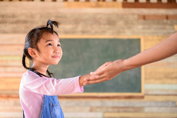 Mom hold little girl hand