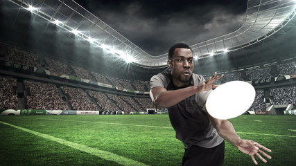 Serious rugby player throwing the ball - Powered by Adobe
