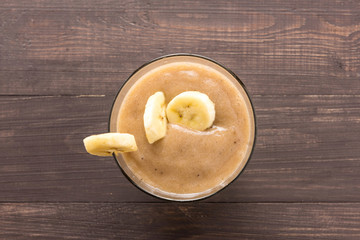Top shot banana smoothie on wooden background