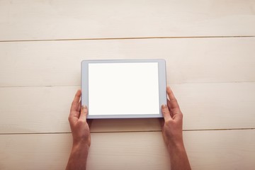 Hands holding blank screen tablet