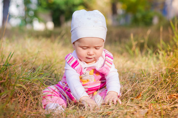 Cute baby in autumn leaves.