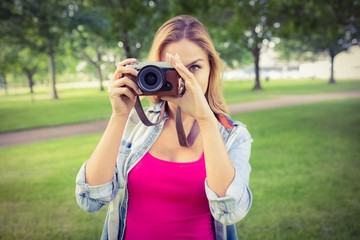 Woman taking picture with camera 