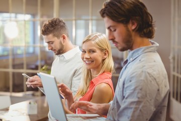 Businesswoman with male colleagues working in creative office