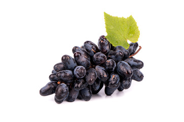 Bunch of black fresh grapes with drops and leaves on a white background
