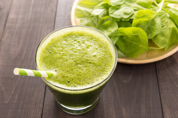 Healthy green smoothie on rustic wood background