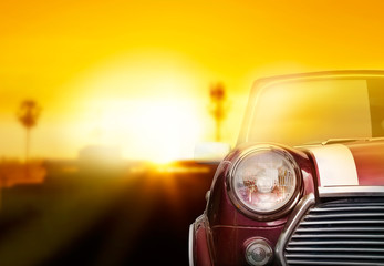 Fototapeta na wymiar Retro car head light on street in the sunset background