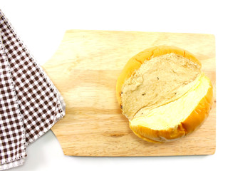 top view of slices bread with butter on a rustic wooden cutting board wooden background