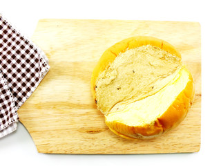 top view of slices bread with butter on a rustic wooden cutting board wooden background
