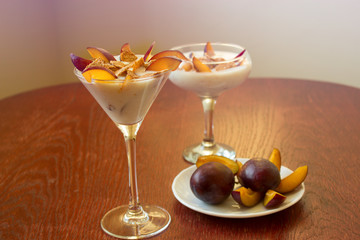 yogurt dessert with plums and wheat flakes. Healthy dessert with