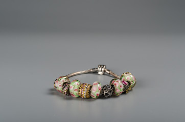 Bracelet with Charms on a gray background