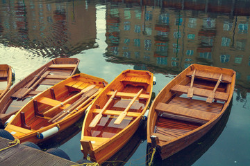 Fototapeta na wymiar Wooden boats on the canal. Buildings reflection