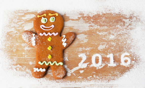 Gingerbread man on  wooden table. 2016 new year.