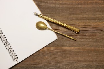Notebook With Blank Page, Spoon And Pen  On Wood Table