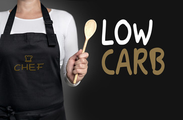 low carb cook holding wooden spoon background concept